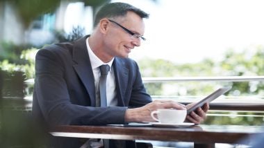 His tablet is his personal assistant man working with tablet
