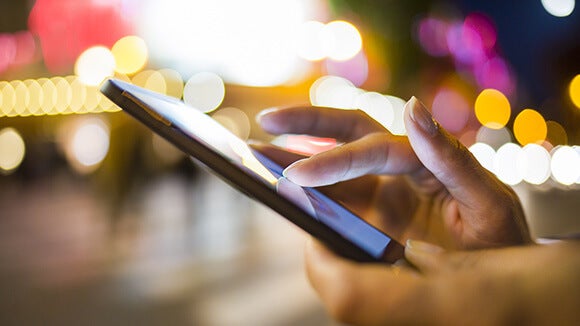 negotiating your salary professional checking salary survey on phone