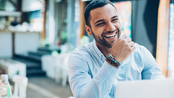 woman smiling in office looking at salary report woman smiling in office looking at salary report