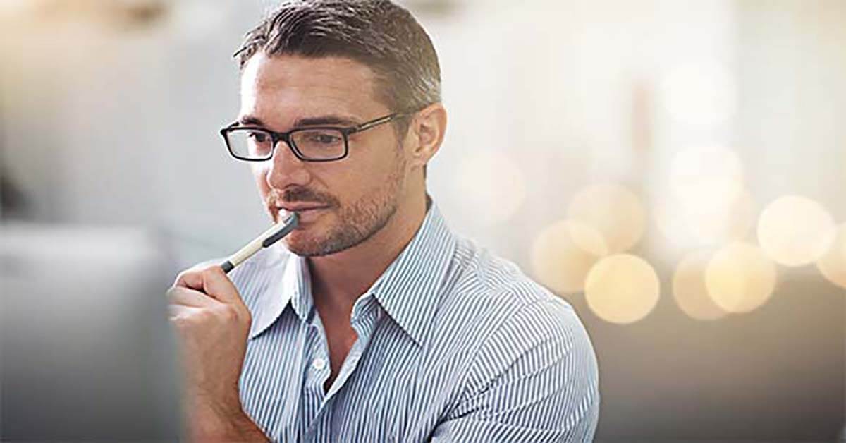 Man with pen at desk